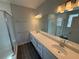 Bright bathroom featuring a double vanity with quartz countertops and sleek fixtures at 652 Pothos St, Apopka, FL 32703