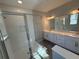 Elegant bathroom with glass-enclosed shower and double vanity with lots of counter space at 652 Pothos St, Apopka, FL 32703
