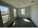 Bedroom featuring multiple windows, grey walls, and wood-look tile flooring at 652 Pothos St, Apopka, FL 32703