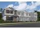 Charming townhome exteriors featuring neutral paint, decorative shutters, and covered front entries, all surrounded by lush landscaping at 652 Pothos St, Apopka, FL 32703