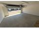 Open, empty two-car garage with white brick walls and lots of natural light at 652 Pothos St, Apopka, FL 32703