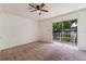 Bright bedroom features a ceiling fan and sliding glass doors to a balcony at 7336 Daniel Webster Dr # 9, Winter Park, FL 32792