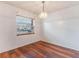 Dining room featuring wood flooring, a chandelier, and a window with blinds at 7336 Daniel Webster Dr # 9, Winter Park, FL 32792