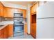 Modern kitchen featuring stainless steel appliances and wooden cabinets at 7336 Daniel Webster Dr # 9, Winter Park, FL 32792