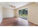 Bright living room featuring hardwood floors, ceiling fan, and sliding glass doors at 7336 Daniel Webster Dr # 9, Winter Park, FL 32792