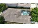 Aerial view of a well-maintained home featuring a screened-in pool and beautifully manicured landscaping at 7415 Devereaux St, Reunion, FL 34747