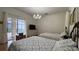 Bright bedroom with hardwood floor features two beds with floral bedding, dresser and view of pool at 7415 Devereaux St, Reunion, FL 34747
