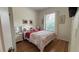 Comfortable bedroom featuring hardwood floor, white dresser, and bed with floral bedding at 7415 Devereaux St, Reunion, FL 34747