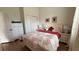 Comfortable bedroom featuring hardwood floor, white dresser, and bed with floral bedding at 7415 Devereaux St, Reunion, FL 34747