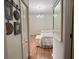 Bright bedroom with a chandelier and two beds featuring floral bedding and white storage benches at 7415 Devereaux St, Reunion, FL 34747