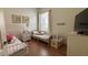 Bright bedroom with hardwood floor features two twin beds with floral bedding, and window at 7415 Devereaux St, Reunion, FL 34747