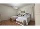 Comfortable bedroom featuring two twin beds, hardwood floors, and soft lighting at 7415 Devereaux St, Reunion, FL 34747