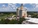 An aerial view of a tall resort building with beautiful landscaping at 7415 Devereaux St, Reunion, FL 34747