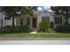 Inviting single-story home featuring a well-manicured lawn and mature trees at 7415 Devereaux St, Reunion, FL 34747