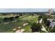 An aerial view shows a meticulously maintained golf course at 7415 Devereaux St, Reunion, FL 34747