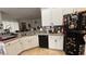 Spacious kitchen with white cabinets, laminate counters, and a black refrigerator at 7415 Devereaux St, Reunion, FL 34747