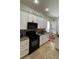 Eat-in kitchen features white cabinets, black appliances, and a breakfast nook at 7415 Devereaux St, Reunion, FL 34747