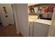 Compact laundry room with washer and dryer featuring built-in shelving for storage at 7415 Devereaux St, Reunion, FL 34747