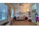Bright living room with hardwood floors, large windows, and playful décor at 7415 Devereaux St, Reunion, FL 34747