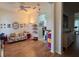 Inviting living room with a sofa, built-in shelves, and hardwood floors at 7415 Devereaux St, Reunion, FL 34747
