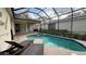 A screened-in pool with lounge chairs offers a relaxing outdoor space at 7415 Devereaux St, Reunion, FL 34747