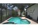 Relaxing screened-in pool area with comfortable lounge chairs and a beautiful view of the surrounding landscape at 7415 Devereaux St, Reunion, FL 34747
