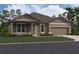 Charming single-story home featuring a neutral color palette, stone accents, and a well-manicured lawn at 756 Pointe Emerson Blvd, Apopka, FL 32703