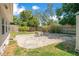 Private backyard featuring a brick patio area with seating, mature trees, and a fenced perimeter at 821 Sutter Loop, Longwood, FL 32750