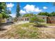 Large backyard features a brick patio, shed, mature trees, and a well-maintained lawn at 821 Sutter Loop, Longwood, FL 32750