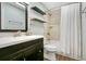 Bathroom with dark wood vanity, shower-tub combo, and decorative mirror at 821 Sutter Loop, Longwood, FL 32750