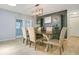 Formal dining room featuring wood floors, designer lighting, a large dining table and a view of the backyard at 821 Sutter Loop, Longwood, FL 32750