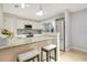 Modern kitchen features white cabinets, granite countertops, stainless steel appliances, and stylish barstool seating at 821 Sutter Loop, Longwood, FL 32750