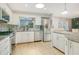 Bright kitchen with white cabinetry, granite countertops, stainless steel appliances, and wood flooring at 821 Sutter Loop, Longwood, FL 32750