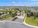 Beautiful aerial view of a new community with a gated entrance, lush landscaping and serene water features at 9007 Pelican Cove Trce, Kissimmee, FL 34747