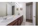 Bathroom featuring double sinks, vanity with cabinet storage, and a large mirror, creating a functional space at 9007 Pelican Cove Trce, Kissimmee, FL 34747