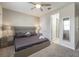 Modern bedroom with gray bed, matching nightstands, and connecting bathroom at 9007 Pelican Cove Trce, Kissimmee, FL 34747