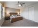 Bedroom featuring a king-size bed, wooden dresser, a ceiling fan, and ample natural light at 9007 Pelican Cove Trce, Kissimmee, FL 34747