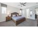 Bright bedroom with a king-size bed, ceiling fan, and ensuite bathroom at 9007 Pelican Cove Trce, Kissimmee, FL 34747