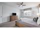Bedroom with a king-size bed, ceiling fan, and TV at 9007 Pelican Cove Trce, Kissimmee, FL 34747