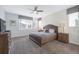 Tranquil bedroom with a king-size bed, ceiling fan, and ample natural light at 9007 Pelican Cove Trce, Kissimmee, FL 34747