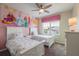 Bedroom with twin beds and Disney princess themed wall art, creating a magical space for  at 9007 Pelican Cove Trce, Kissimmee, FL 34747