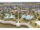 Aerial view of the community pool and clubhouse with ample seating, waterslide, and splash pad at 9007 Pelican Cove Trce, Kissimmee, FL 34747