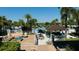Relaxing community pool area with a bar and lounge seating surrounded by palm trees at 9007 Pelican Cove Trce, Kissimmee, FL 34747