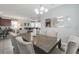 Open concept dining area with seating for eight and a view of the kitchen and living room at 9007 Pelican Cove Trce, Kissimmee, FL 34747