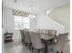 Dining room with seating for eight, neutral decor, and natural light at 9007 Pelican Cove Trce, Kissimmee, FL 34747