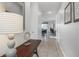 Inviting hallway with tile flooring, neutral paint, and access to various rooms at 9007 Pelican Cove Trce, Kissimmee, FL 34747