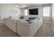 Comfortable living room showcasing a large sectional, ceiling fan, and a flat screen TV at 9007 Pelican Cove Trce, Kissimmee, FL 34747