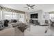 Spacious living room with large sectional sofa, TV, and access to outdoor lanai at 9007 Pelican Cove Trce, Kissimmee, FL 34747
