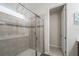 Modern glass shower with neutral tile surround and a sleek design, providing a luxurious bathing experience at 9007 Pelican Cove Trce, Kissimmee, FL 34747