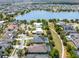 An elevated shot showcasing properties with pools, lush greenery, and a tranquil lake in the background at 9405 Bordet Ct, Orlando, FL 32827